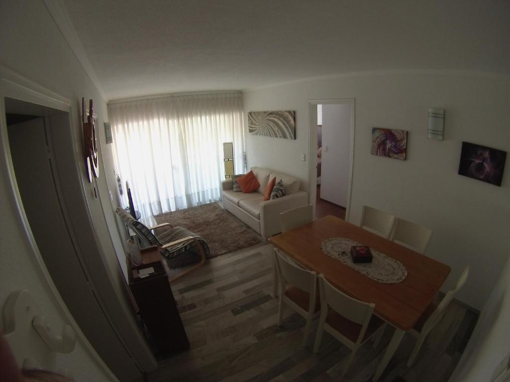 a living room with a table and a couch at Excelente apartameto en Punta del Este in Punta del Este