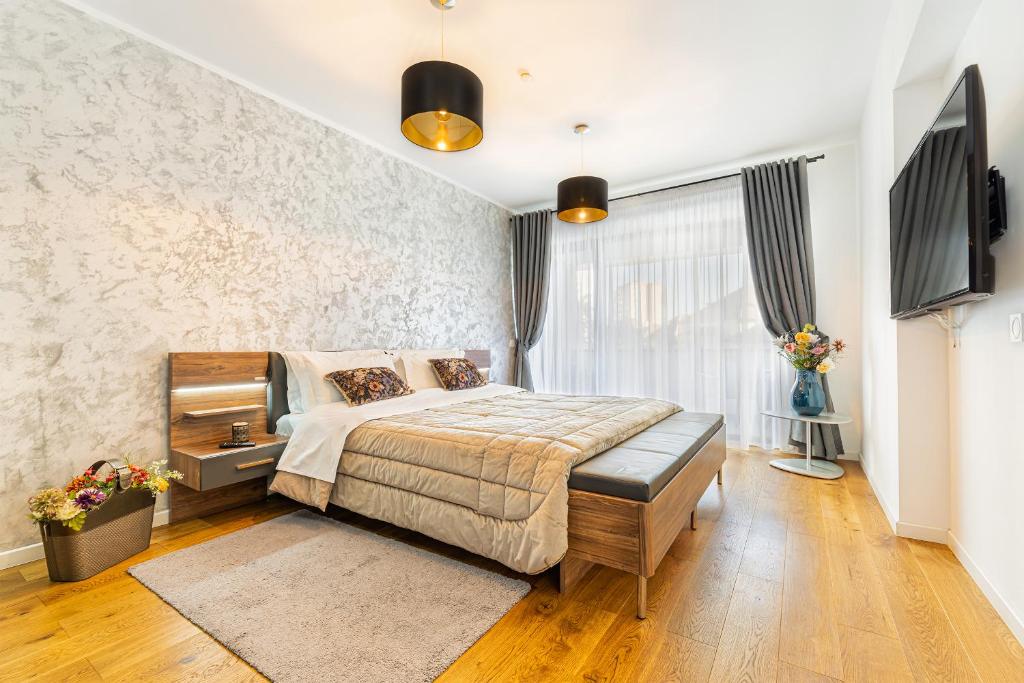 a bedroom with a bed and a television in it at The Wolf Residence in Braşov