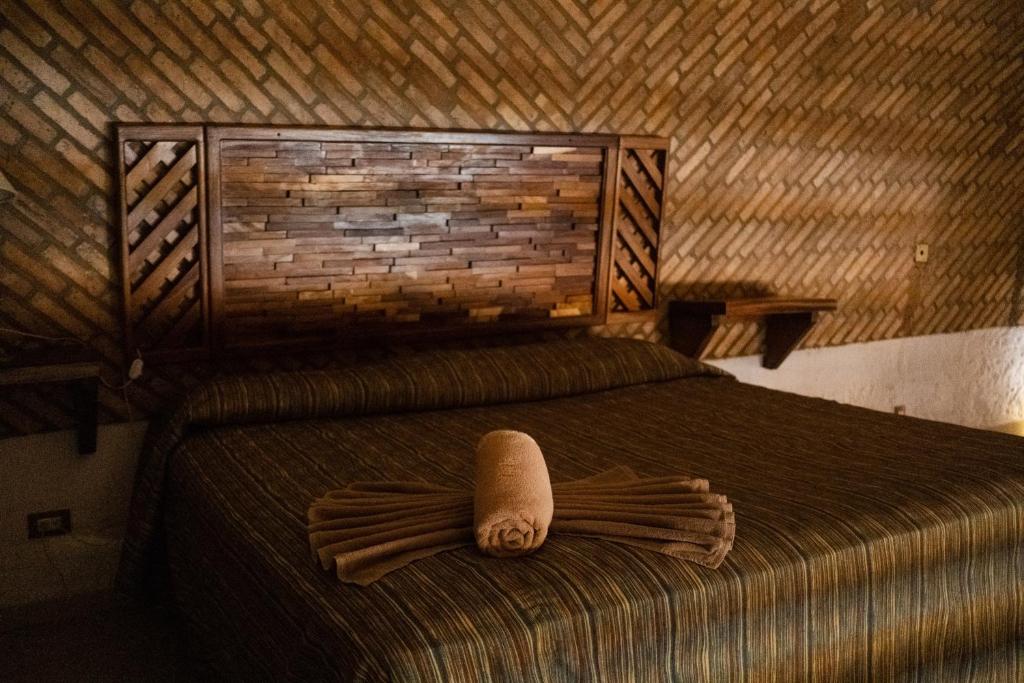 a bedroom with a bed with a pillow on it at Las Casitas in Rincon de Guayabitos