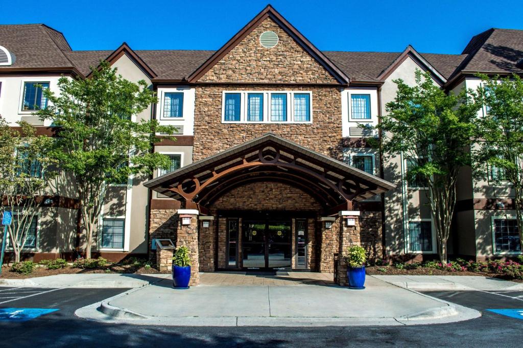 a large brick building with an entry way at Sonesta ES Suites Atlanta Alpharetta Avalon in Alpharetta