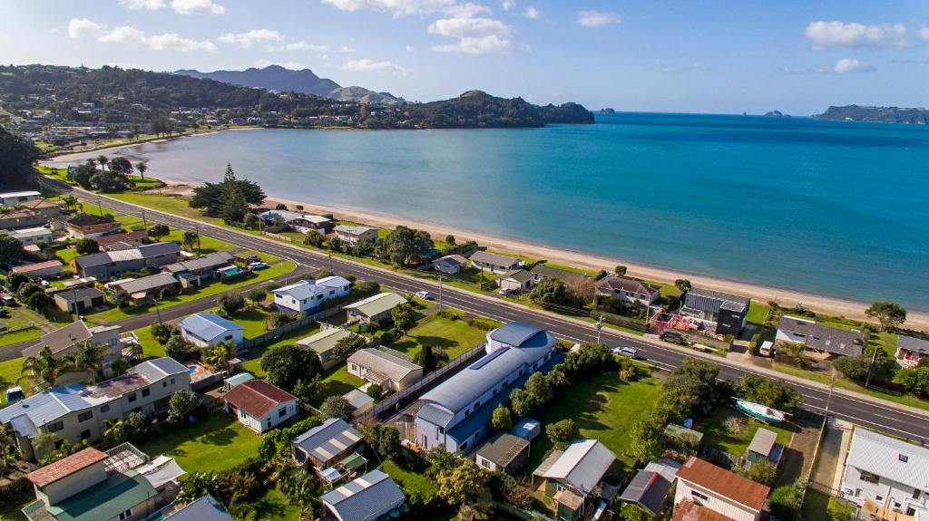an aerial view of a city and a beach at Bayside Motel Whitianga in Whitianga