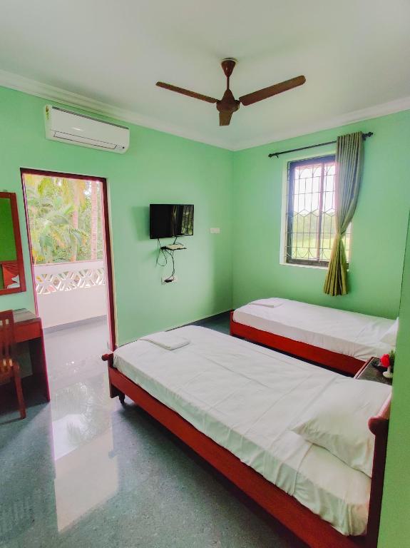 Postel nebo postele na pokoji v ubytování Hotel Siesta De Goa