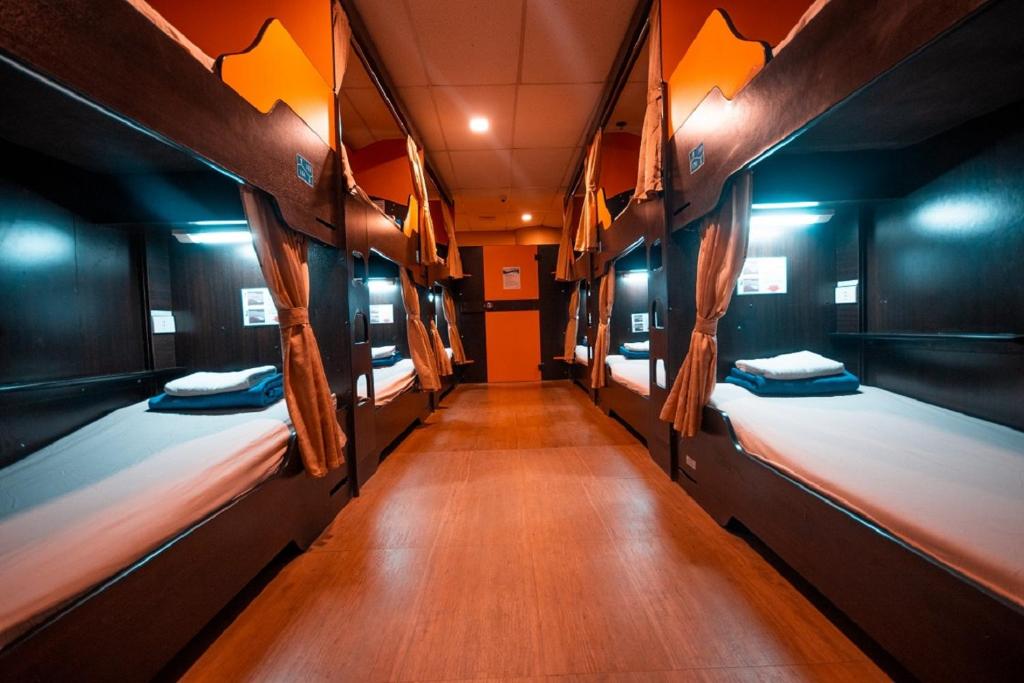 a hallway with three beds in a room at Sugbutel Family Hotel in Cebu City