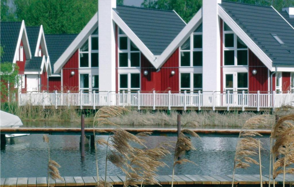 a row of houses with red and white at Beach Front Home In Wendisch-rietz With Sauna in Wendisch Rietz