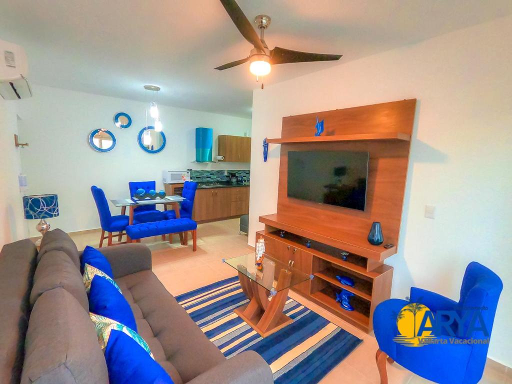 een woonkamer met een bank en een flatscreen-tv bij Disfruta Vallarta, lindo departamento, gran ubicación alberca, nuevo in Puerto Vallarta