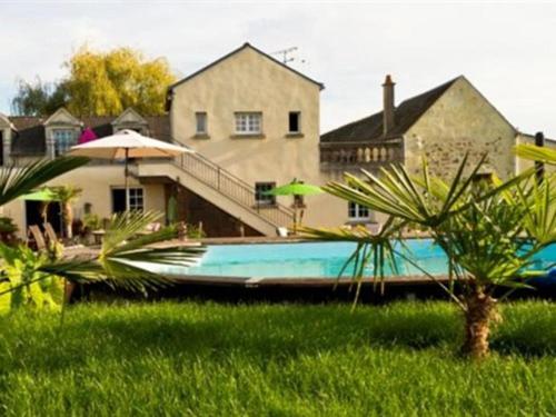 a blue boat sitting in front of a house at Le Clos Marie in Langeais