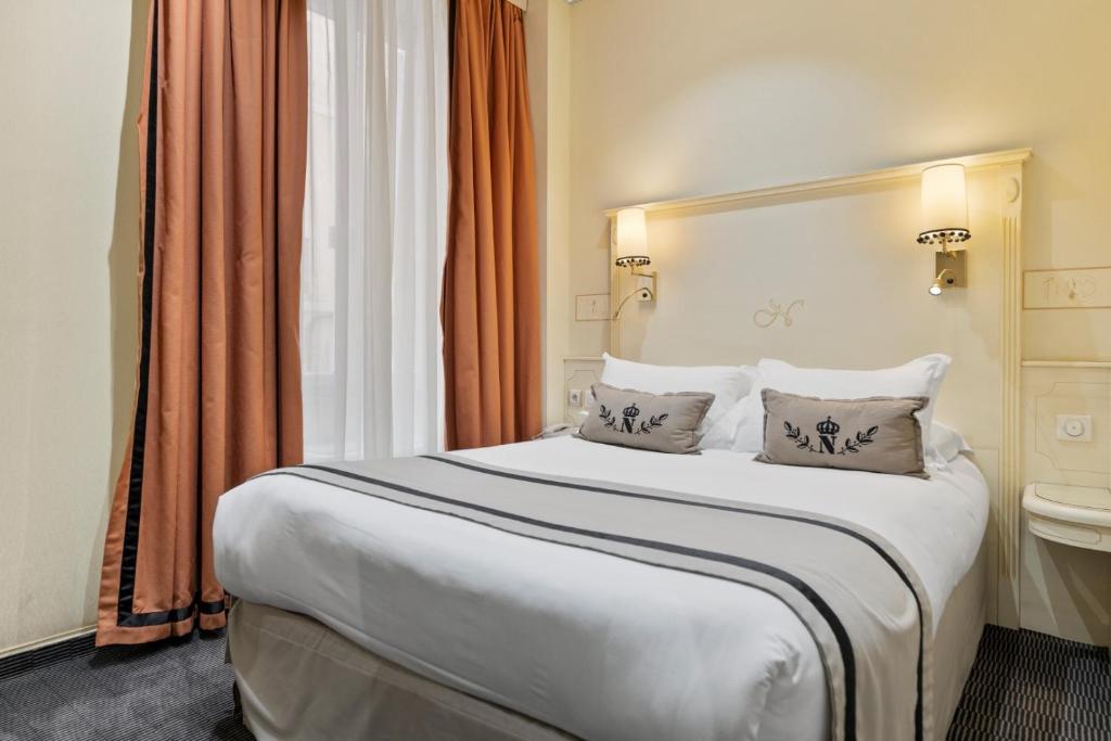 a hotel room with a bed and a toilet at Napoleon in Ajaccio