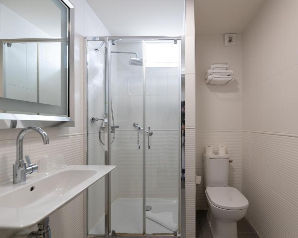 a bathroom with a shower and a sink and a toilet at Napoleon in Ajaccio