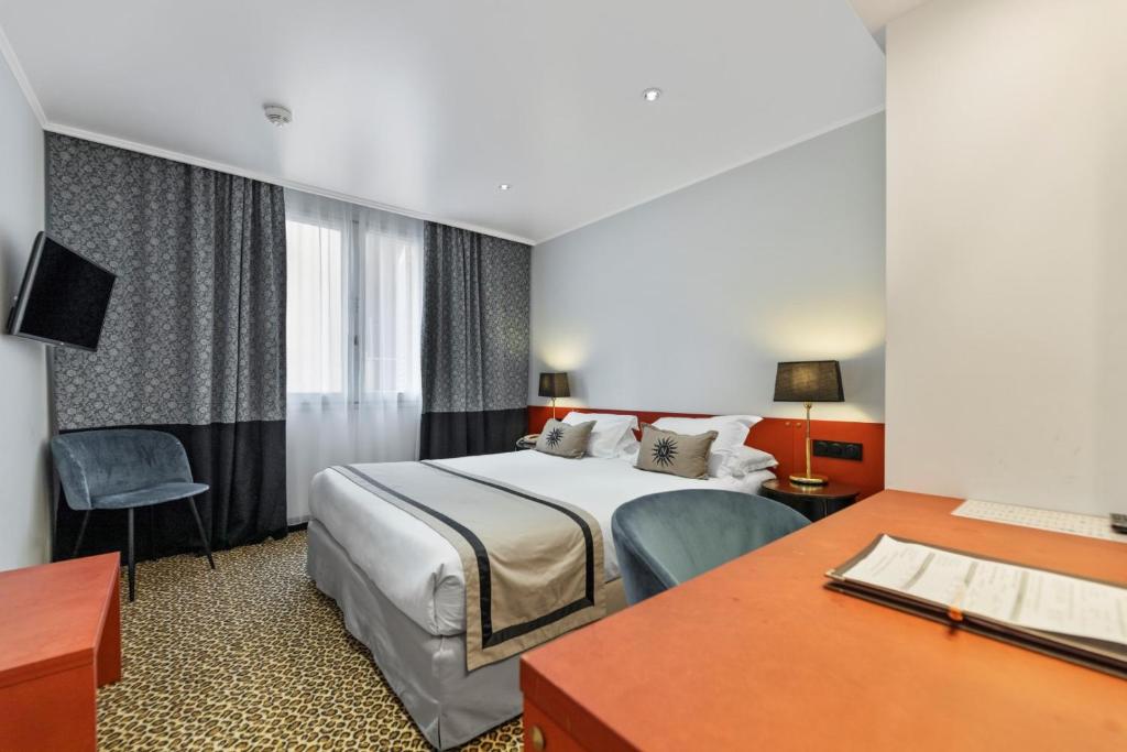a hotel room with a bed and a desk at Napoleon in Ajaccio