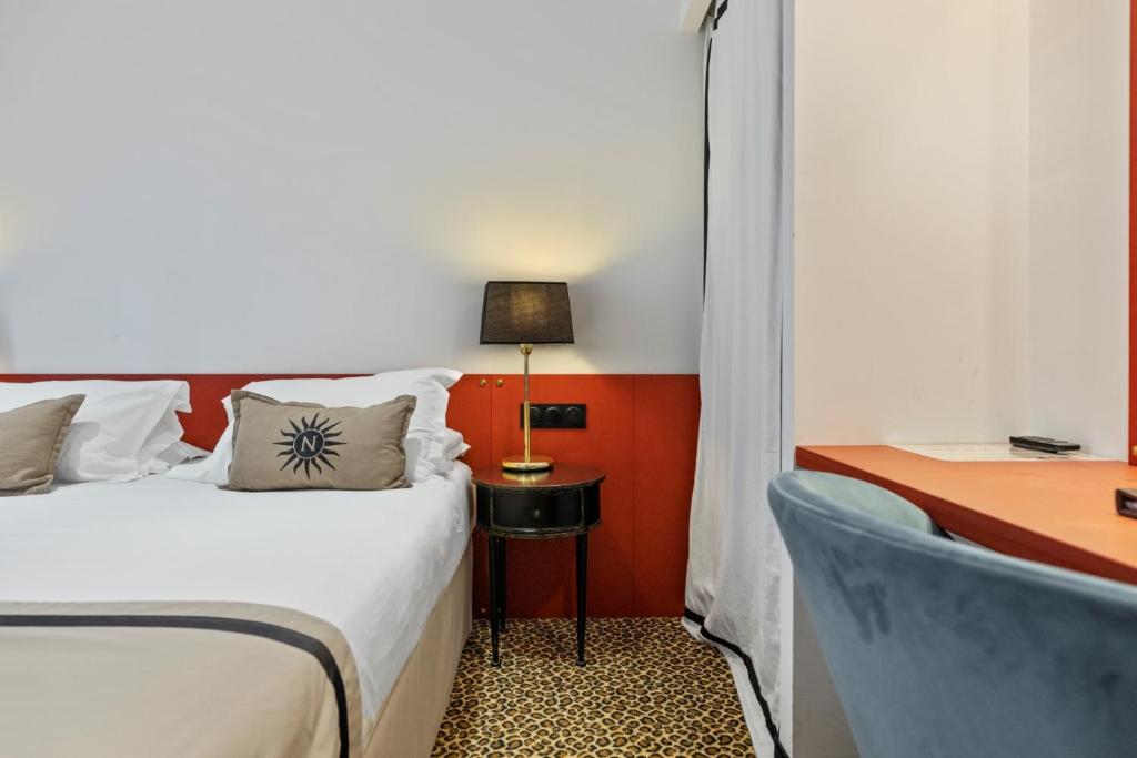 a bedroom with a bed and a desk with a lamp at Napoleon in Ajaccio