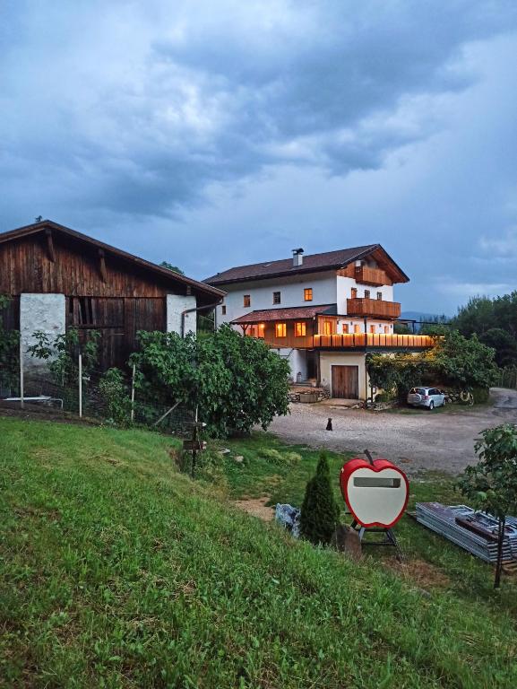 a house with a heart sign in front of it at Winklerhof in Parcines