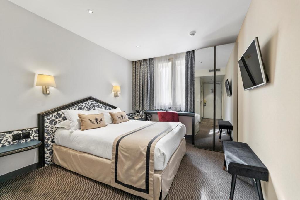 a hotel room with a bed and a mirror at Napoleon in Ajaccio