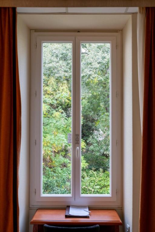 a window in a room with a wooden table at Napoleon in Ajaccio