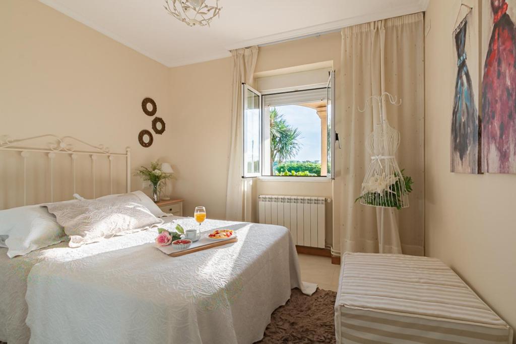 a bedroom with a bed with a tray of fruit on it at Turismo Casa Benito in Villanueva de Arosa