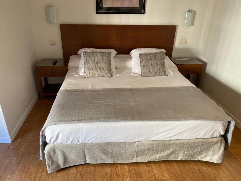 a bedroom with a large bed with two night stands at Rincón de Gran Vía in Madrid
