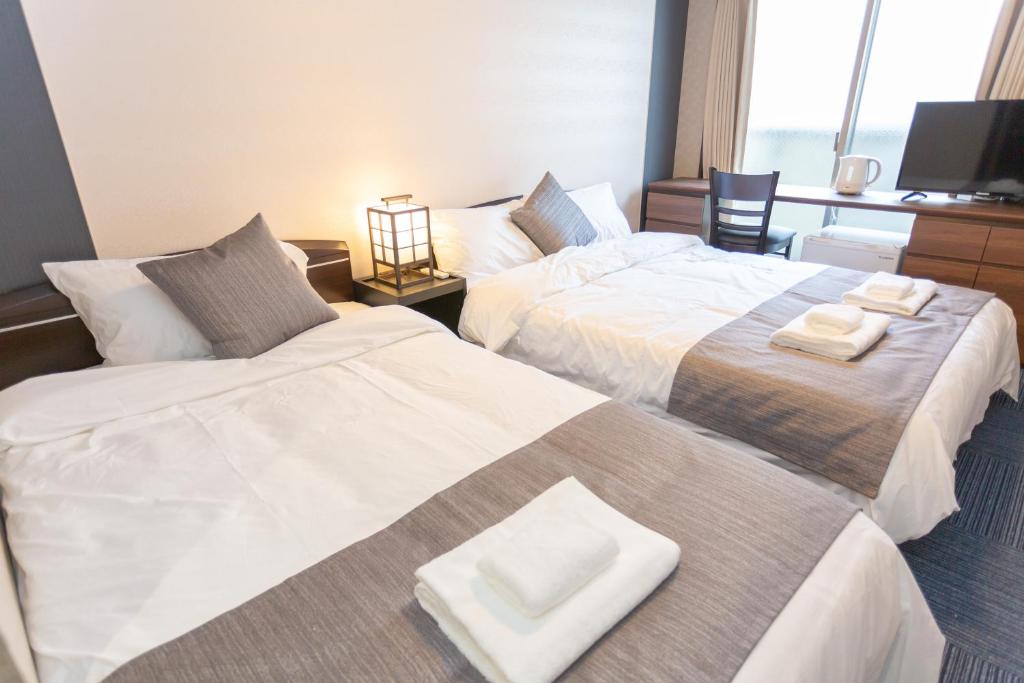 Postel nebo postele na pokoji v ubytování SlowTime Hotel Kyoto
