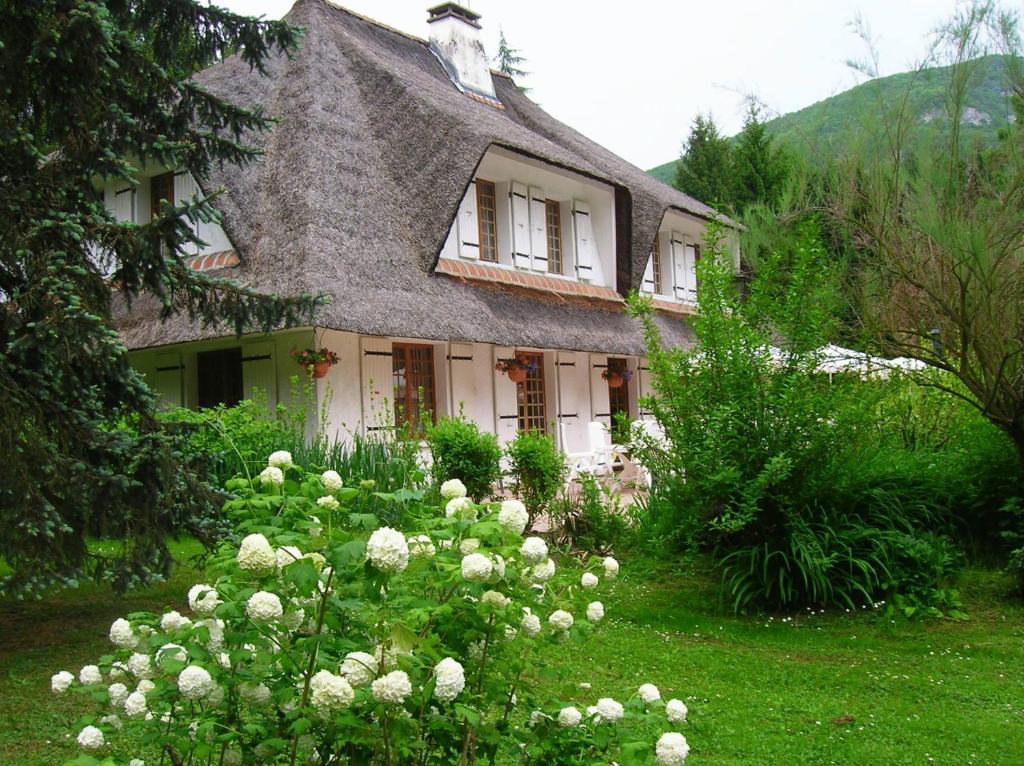 a house with a bunch of flowers in front of it at La Chrissandière in La Balme-de-Sillingy