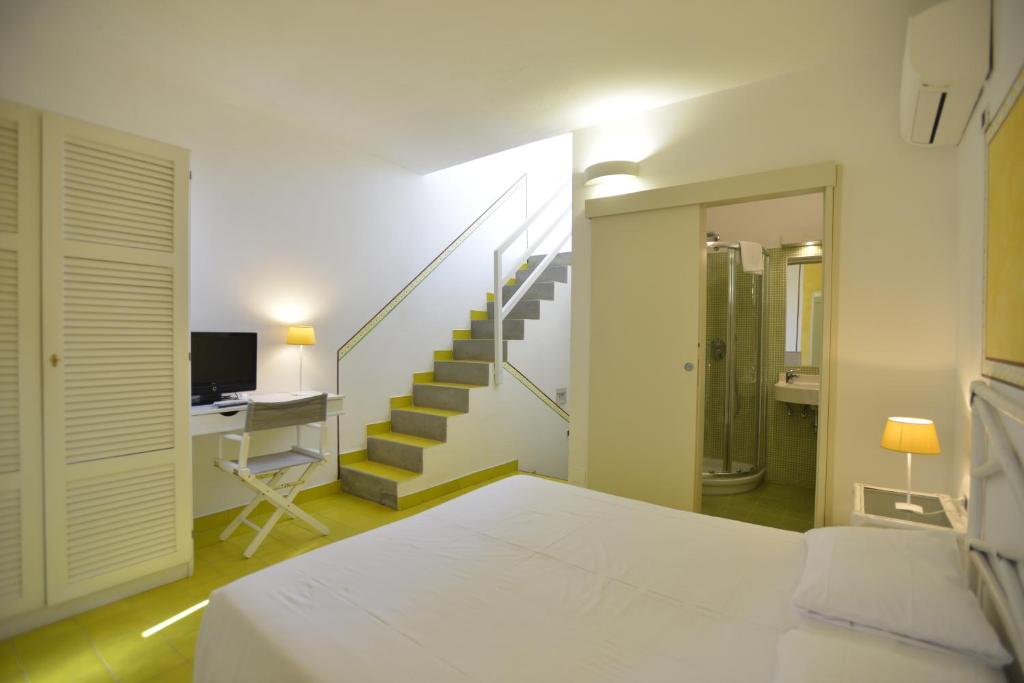 Postel nebo postele na pokoji v ubytování UNAHOTELS Club Hotel Ancora