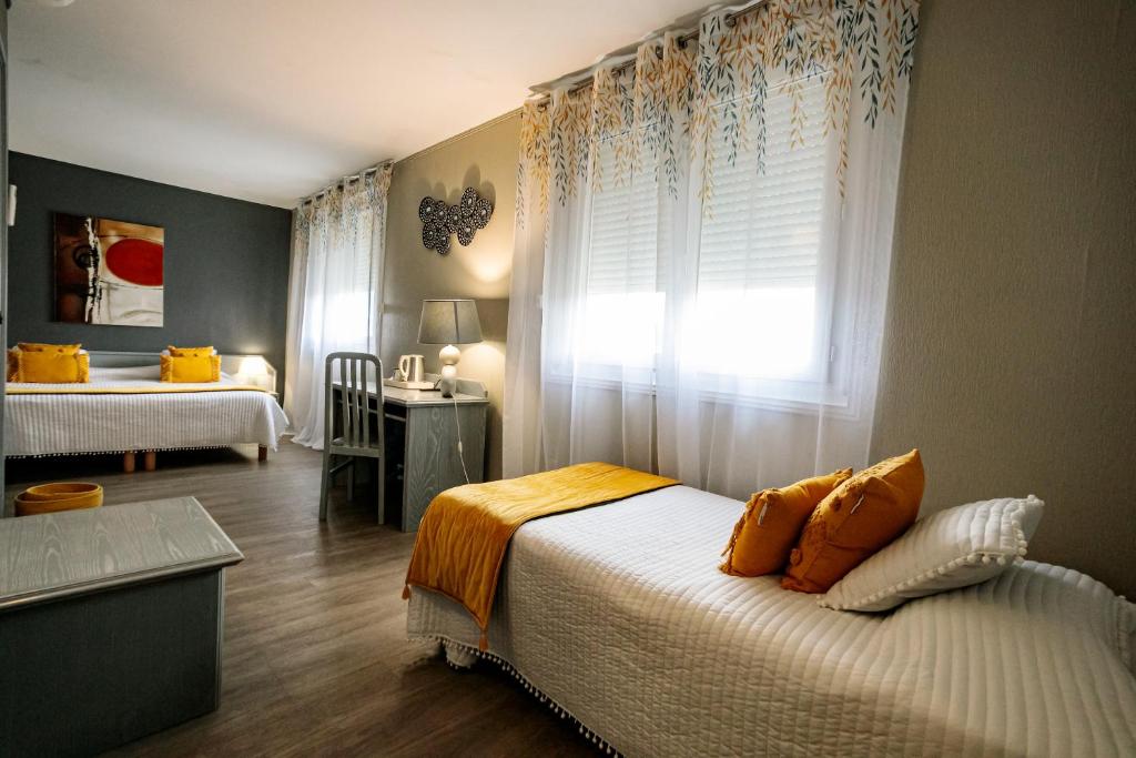 a bedroom with a bed with orange pillows and a window at Hôtel Spunta Di Mare in Ajaccio