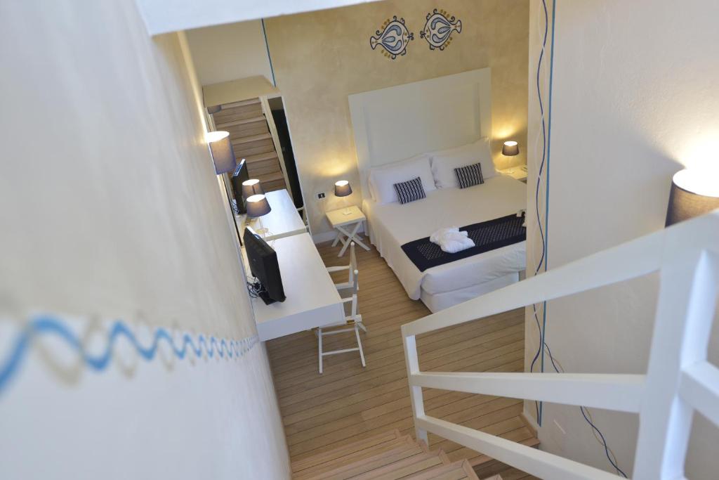 Postel nebo postele na pokoji v ubytování UNAHOTELS Club Hotel Ancora