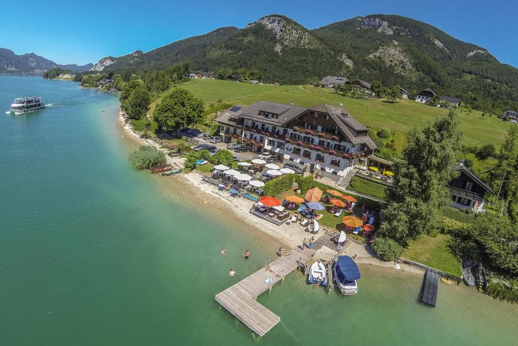 an aerial view of a resort with a dock in the water at Hotel Seehang Garni in St. Wolfgang