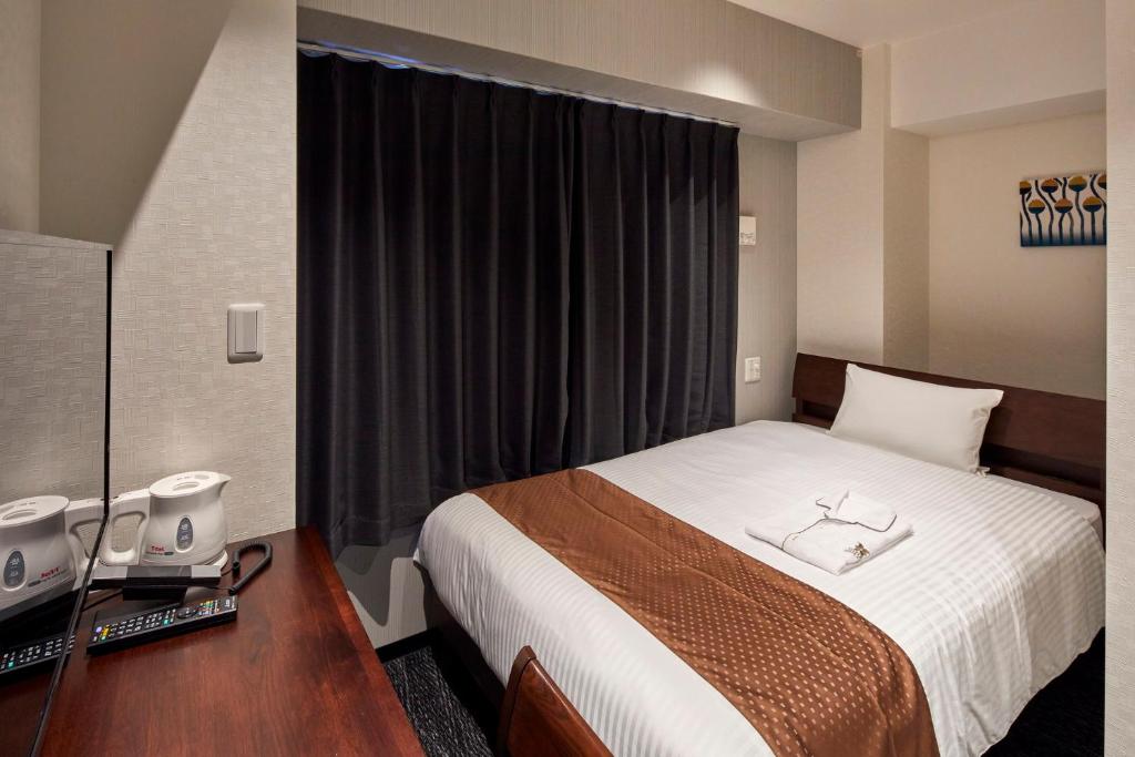 Postel nebo postele na pokoji v ubytování HOTEL BRILLER Kyoto Station South