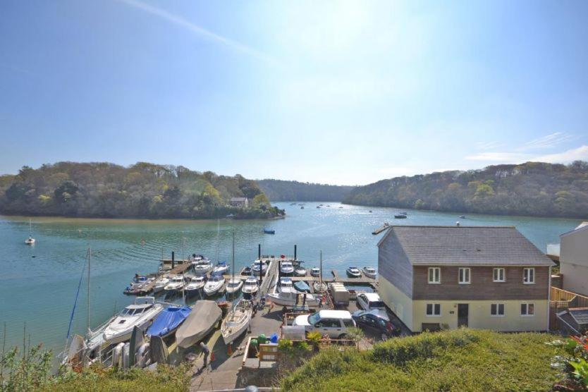 a group of boats docked in a marina on a river at Waterfront House in Saint Clement