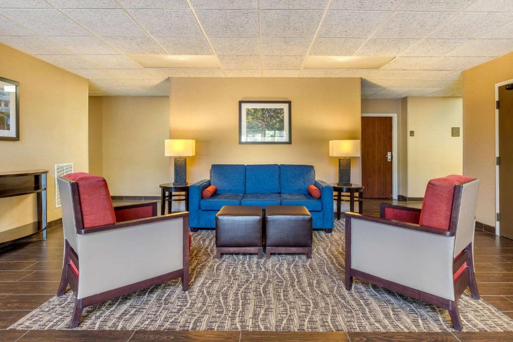 sala de estar con sofá azul y 2 sillas en Comfort Inn Summerville - Charleston, en Summerville