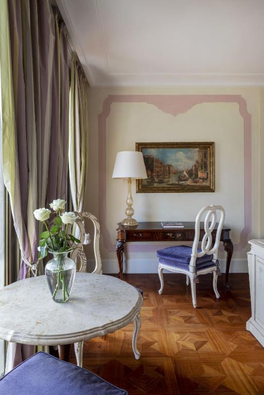 a living room with a table and a vase of flowers at Hotel Cipriani, A Belmond Hotel, Venice in Venice