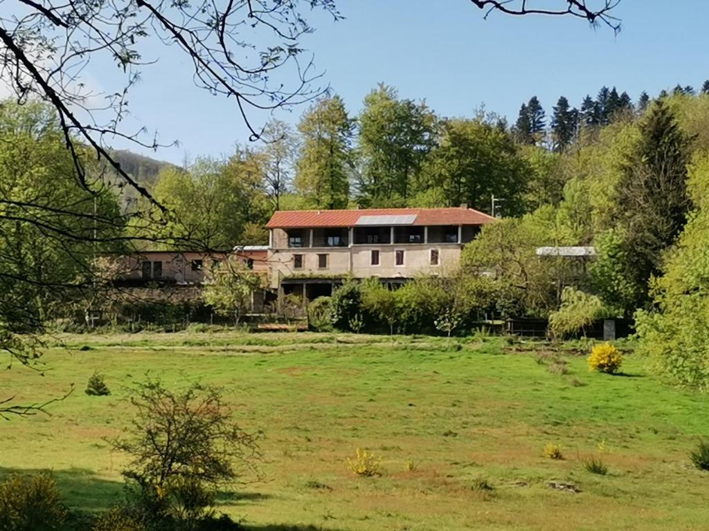 a large house in the middle of a field at B and B Sycomore, La Bouriotte in Labastide-Rouairoux