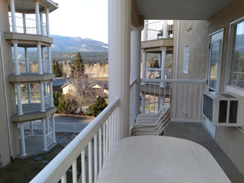 a balcony of a house with a view of the mountains at Fairmont Mountain View Villas in Fairmont Hot Springs