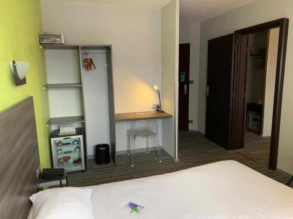 Postel nebo postele na pokoji v ubytování Hôtel Bagatelle