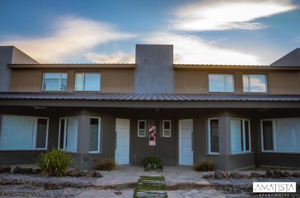 a large house with a lot of windows at Amatista in Chos Malal