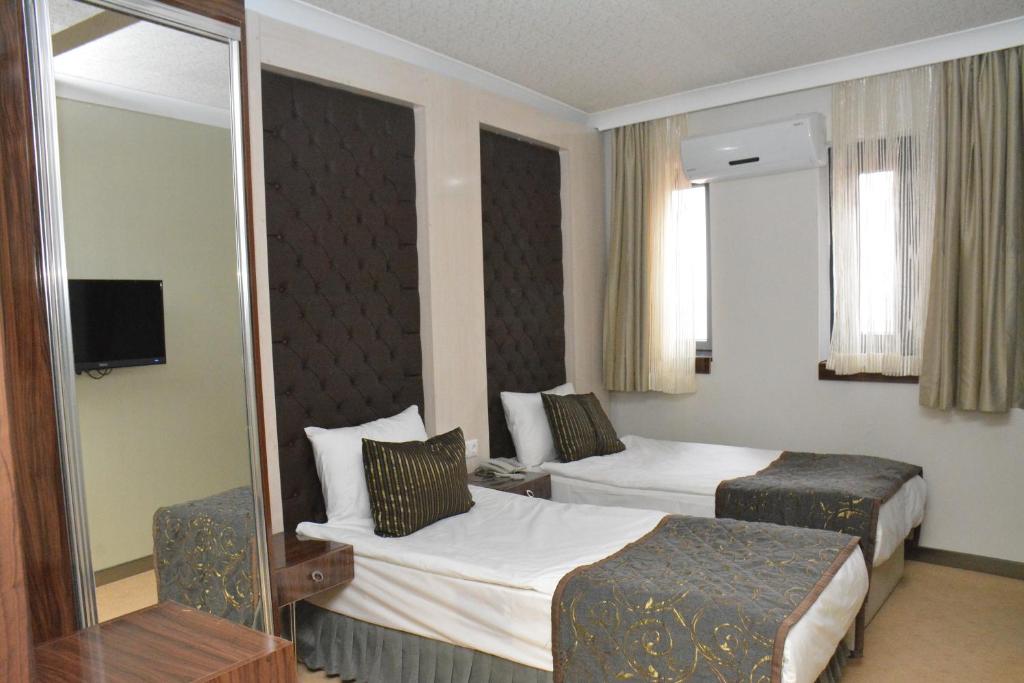 Postel nebo postele na pokoji v ubytování koza millenyum hotel&spa