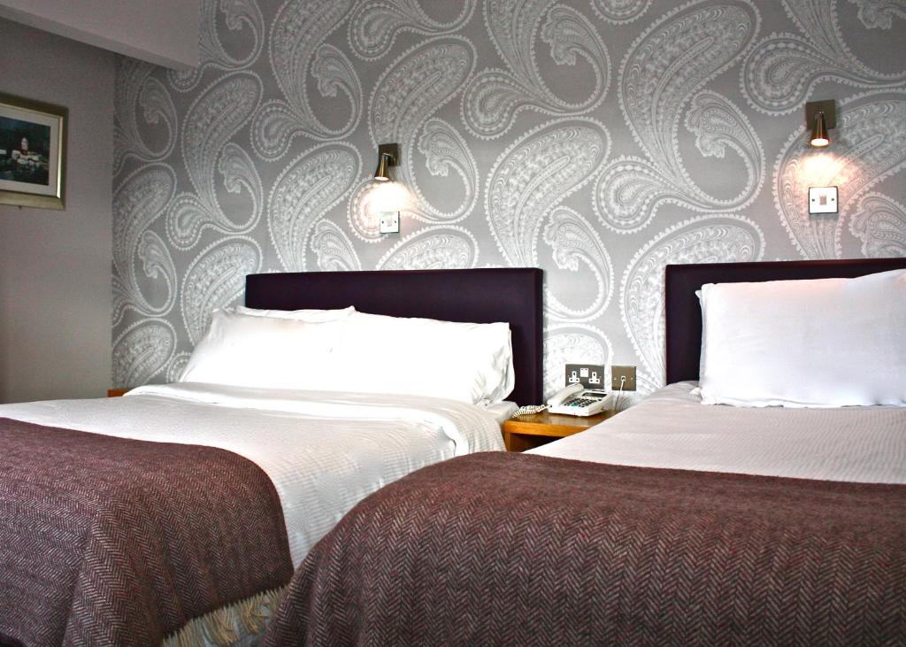 Postel nebo postele na pokoji v ubytování Jackson Court Hotel
