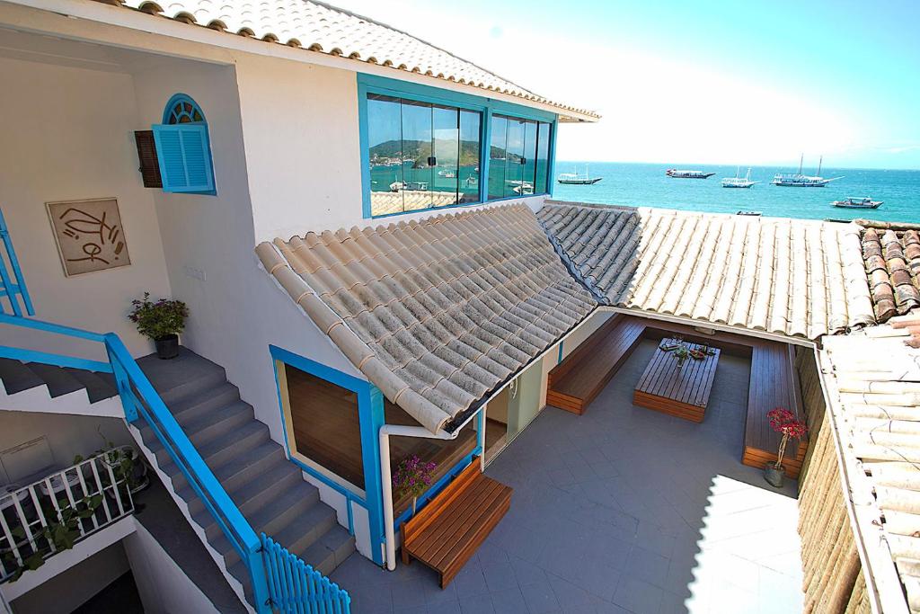 a house with stairs and a view of the ocean at Sofia's on the Beach in Búzios
