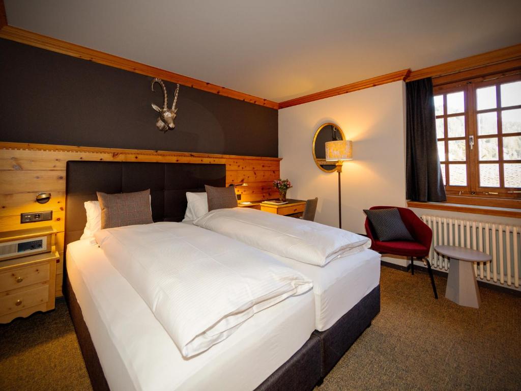 Postel nebo postele na pokoji v ubytování Hotel Parsenn