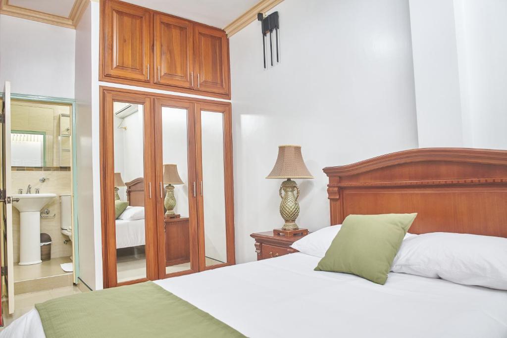 1 Schlafzimmer mit 2 Betten und einem Spiegel in der Unterkunft DEPARTAMENTOS MARCECILIA DE 2 y 3 HABITACIONES EN EL CENTRO DE MANTA in Manta