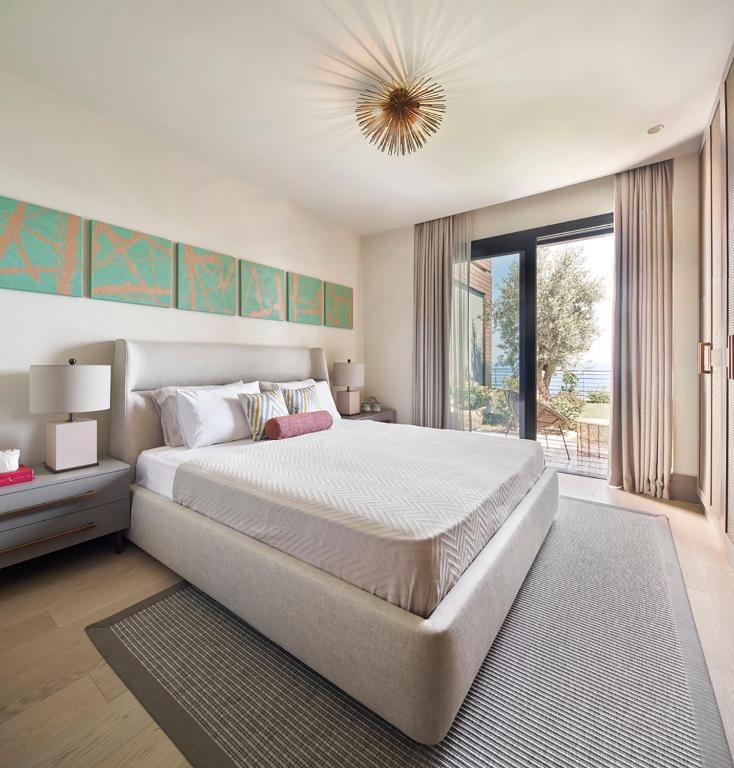a bedroom with a large bed and a large window at Root Redrock Yalıkavak in Yalıkavak