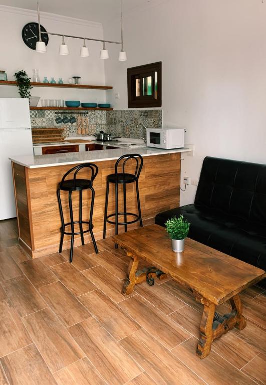 a living room with a table and two bar stools at CASA MAREA in Caleta de Caballo