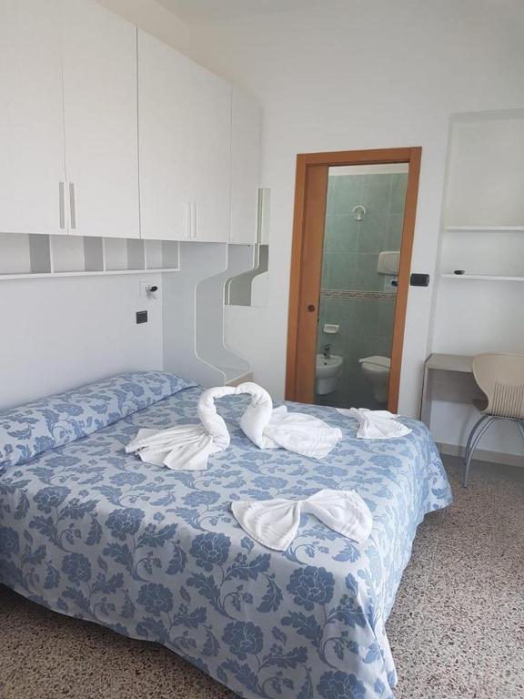 Postel nebo postele na pokoji v ubytování Hotel Zurigo