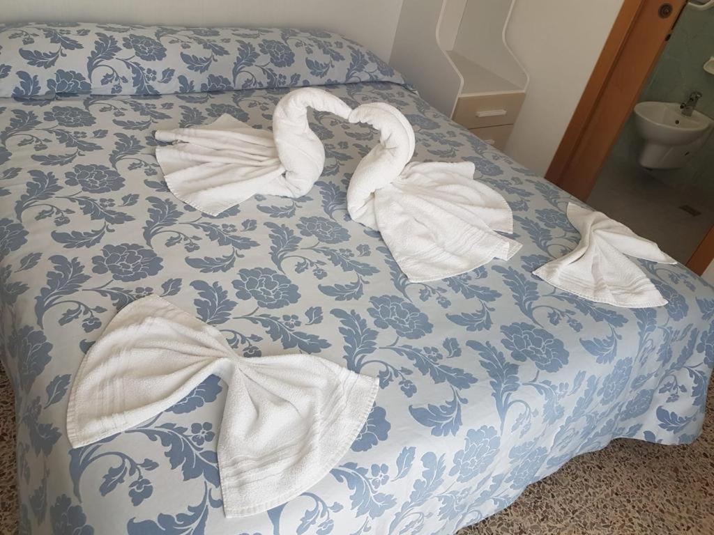 Postel nebo postele na pokoji v ubytování Hotel Zurigo