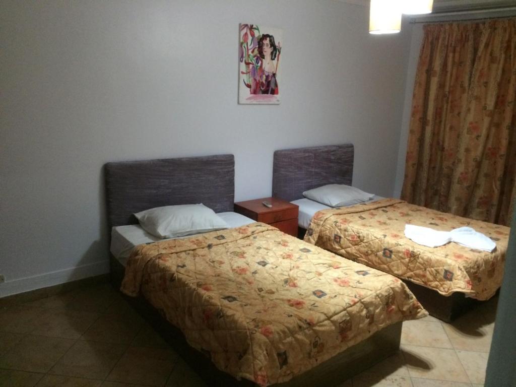 Postel nebo postele na pokoji v ubytování Arabesque Hotel