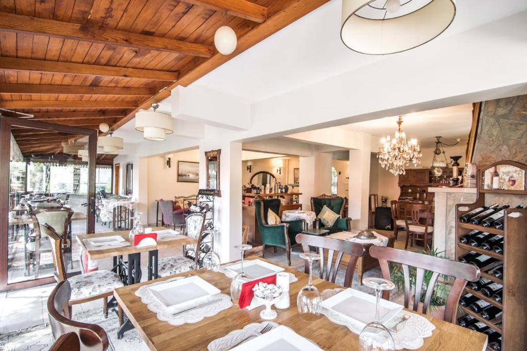 a dining room with tables and chairs and a wine cellar at Park Mandalin Hotel - Adult only in Ağva