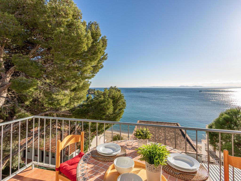 a table on a balcony with a view of the ocean at Apartment Santa Lucia by Interhome in Montjoys