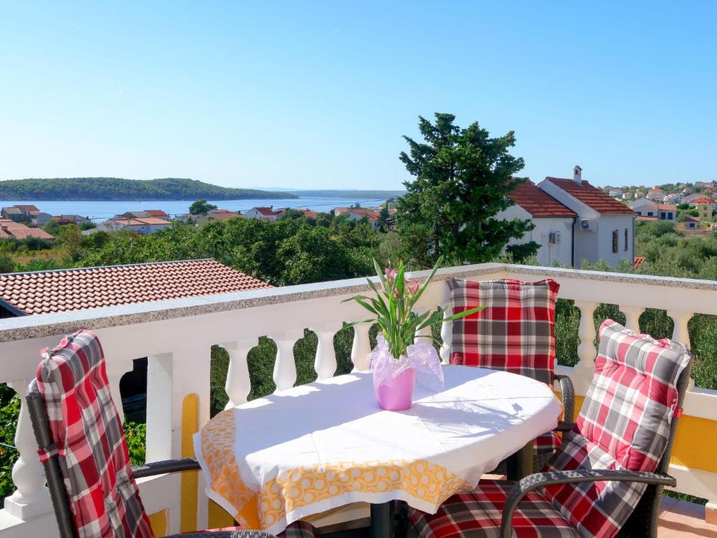 a table and chairs on a balcony with a view at Apartment Sonja by Interhome in Rab