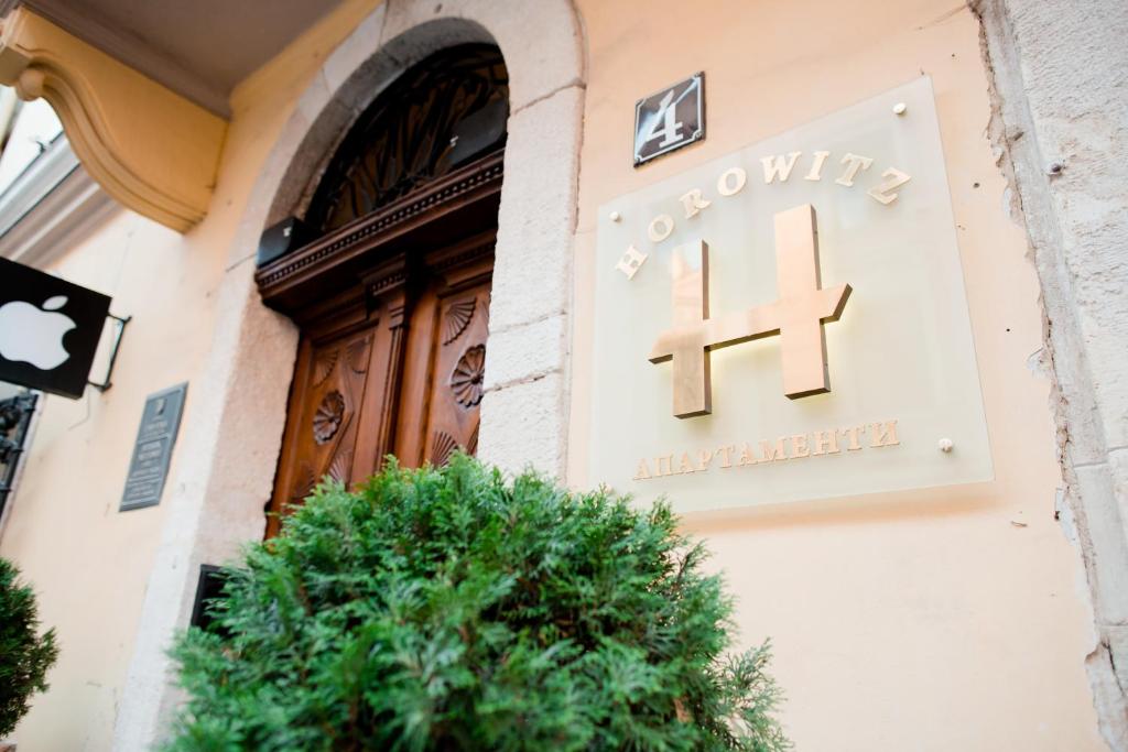 
a doorway leading to a building with a plant in front of it at Apart-hotel Horowitz in Lviv
