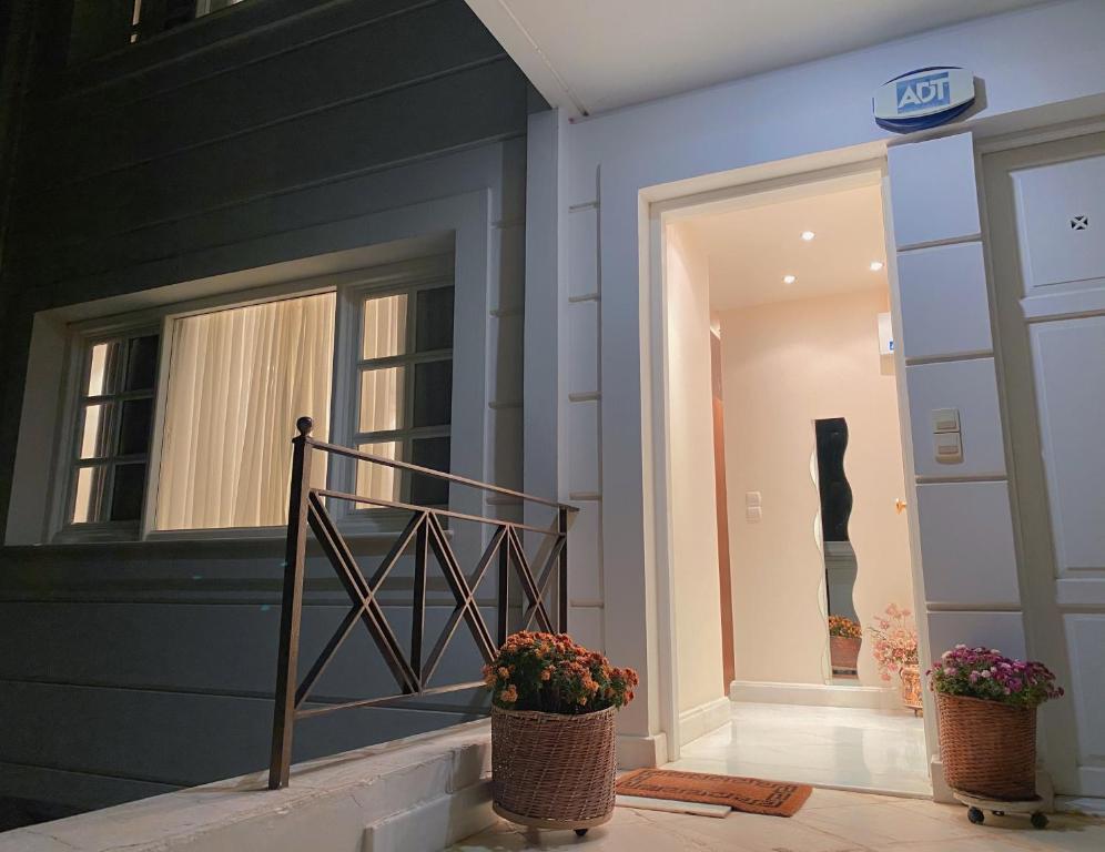 a store with two potted plants in front of a building at Pendeli's Luxury in Athens