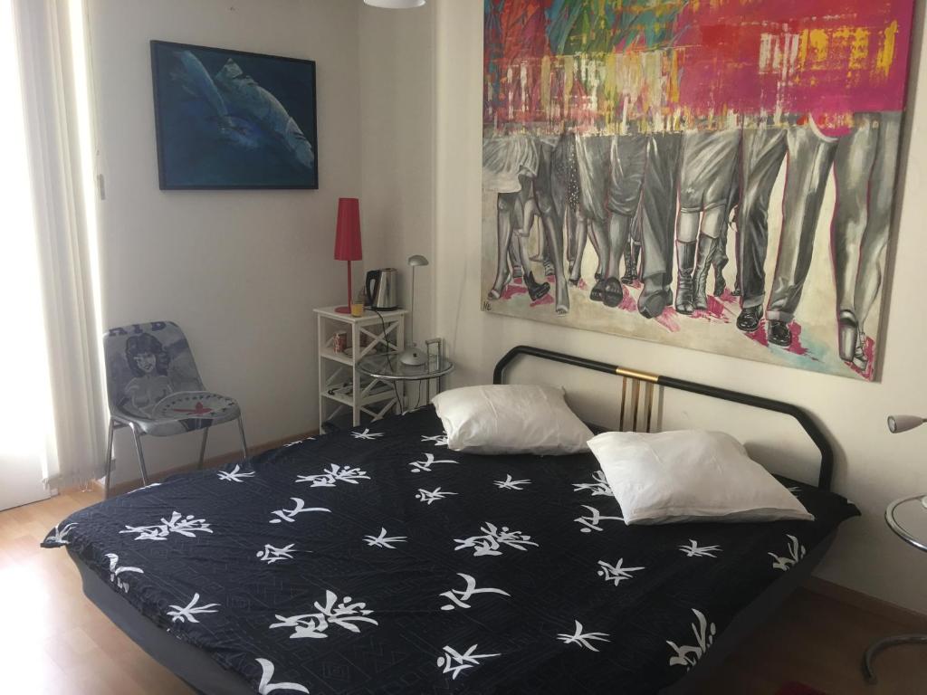 a bedroom with a bed with a black and white comforter at CASA DOYA - Appartamento vintage in Muralto