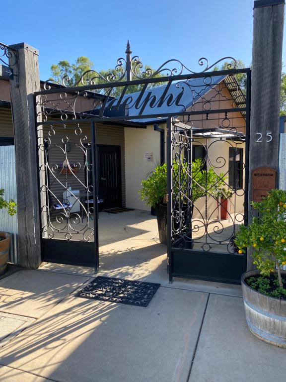 a gate to a store with a sign on it at Adelphi Apartment 4 in Echuca